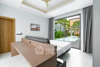 Luxurious bedroom with pool view and modern decor in a tropical setting.