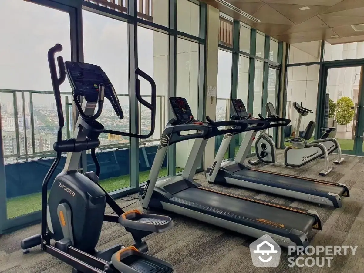 Modern gym with city view and state-of-the-art fitness equipment