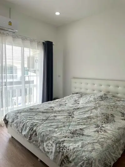 Cozy bedroom with large window and modern decor