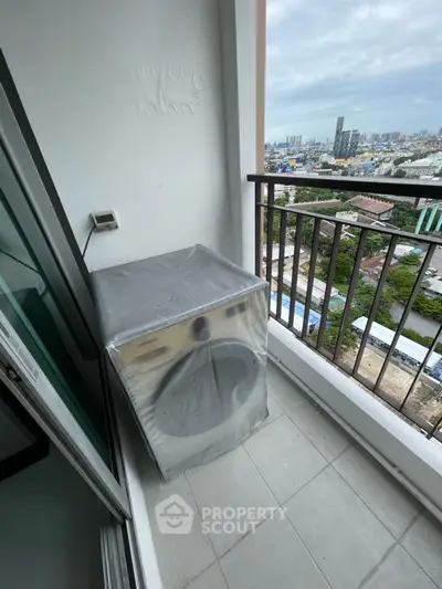 High-rise balcony with washer and stunning city view, perfect for urban living.