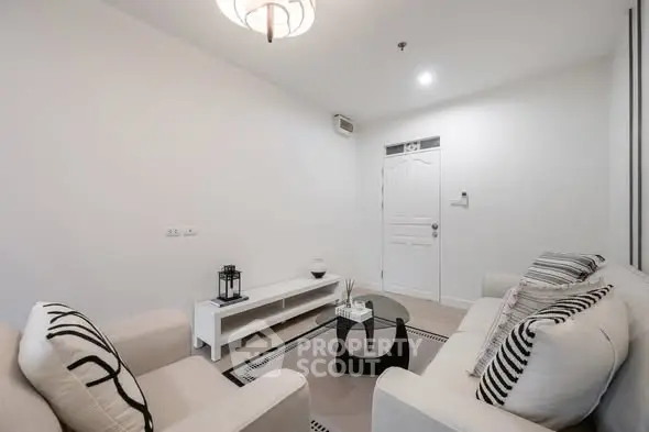 Modern minimalist living room with white decor and cozy seating