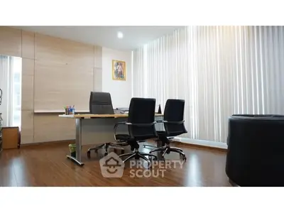 Modern office space with sleek furniture and wooden flooring