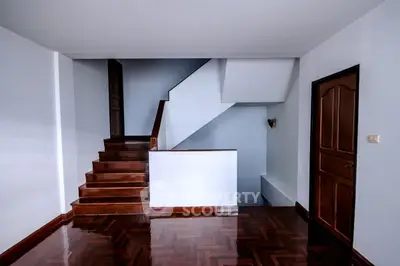 Spacious interior with polished wooden floors and elegant staircase