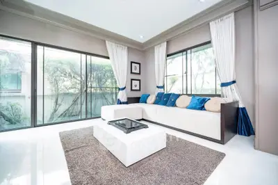 Spacious modern living room with large windows and elegant decor