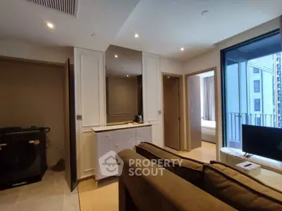 Modern apartment interior with cozy living room and view of bedroom and balcony.