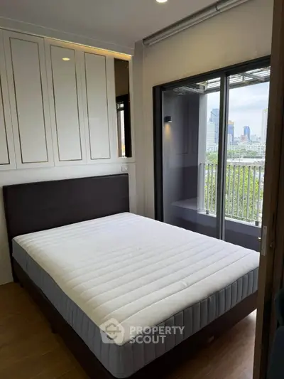 Modern bedroom with balcony view in urban apartment