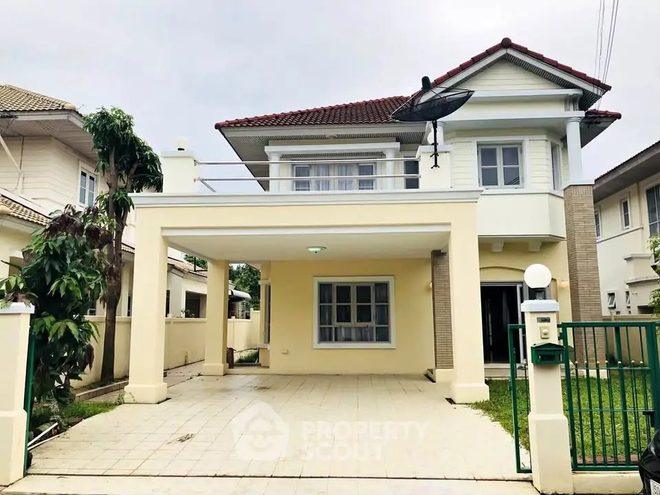 Charming two-story house with spacious driveway and lush greenery in a serene neighborhood.