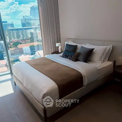 Luxurious bedroom with stunning city view and elegant decor in modern apartment.