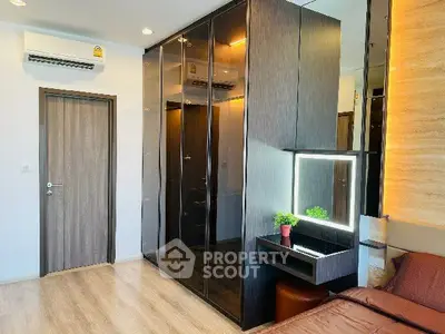 Modern bedroom with sleek mirrored wardrobe and stylish decor