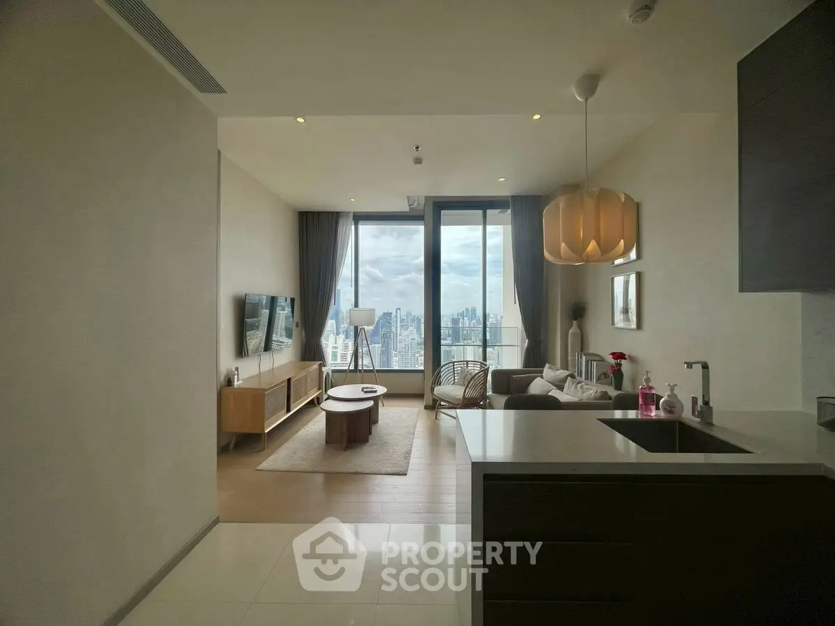 Modern living room with stunning city view, elegant decor, and open layout in high-rise apartment.