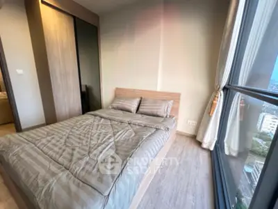 Modern bedroom with large window and stylish decor in urban apartment