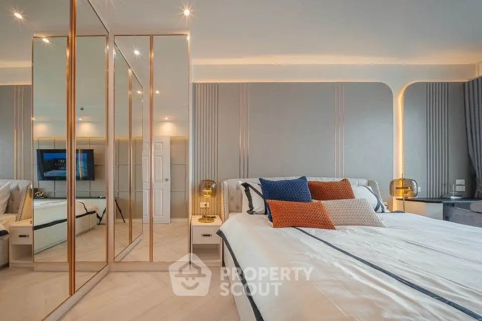 Luxurious bedroom with mirrored closet and elegant lighting