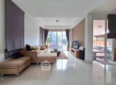 Spacious living room with modern decor and large windows offering natural light.