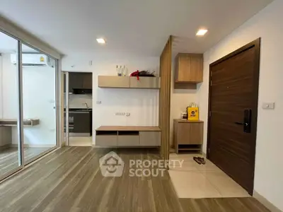 Modern apartment interior with wooden flooring and sleek kitchen design