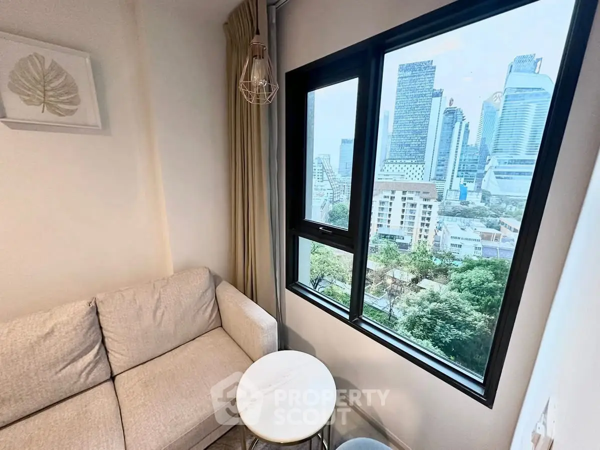 Cozy living room with city view, featuring a modern sofa and stylish decor.