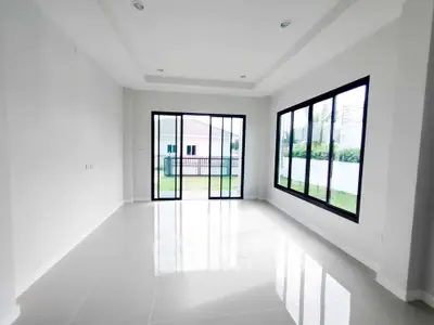 Spacious modern living room with large windows and garden view