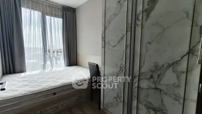 Modern bedroom with large window and stylish marble accents