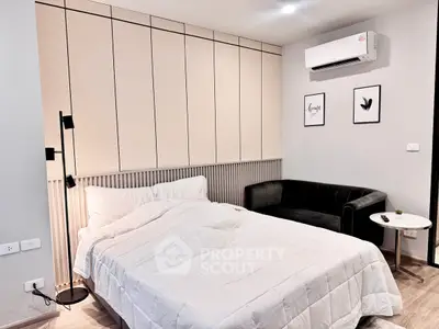 Modern bedroom with cozy bed, stylish sofa, and elegant decor