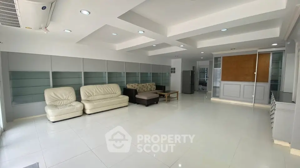 Spacious modern living room with sleek design and ample seating.