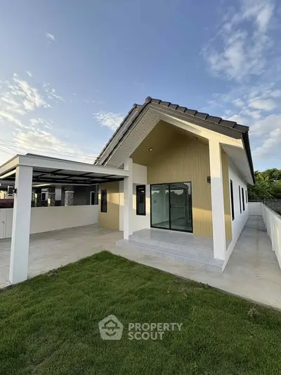 Modern single-story house with sleek design and spacious driveway.