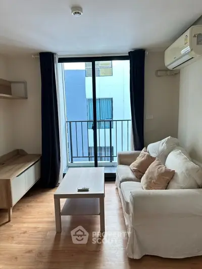 Cozy living room with balcony access and modern furnishings
