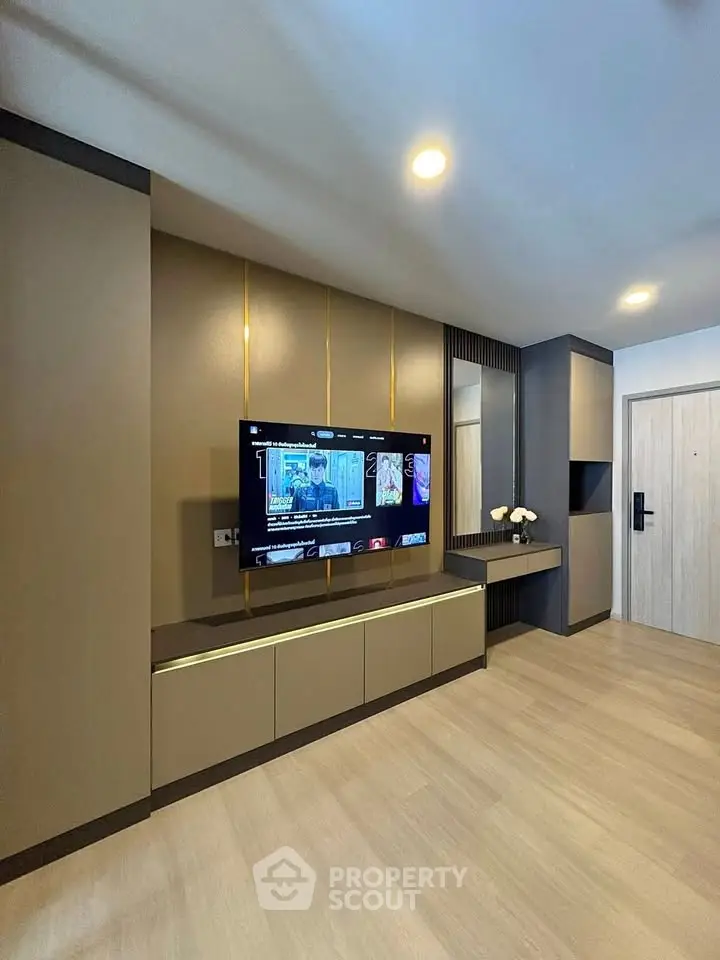 Modern living room with sleek TV unit and elegant decor in a contemporary apartment.