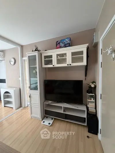 Modern living room with stylish TV unit and wooden flooring