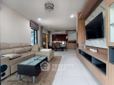 Spacious modern living room with elegant decor and open layout, featuring a cozy seating area and dining space.