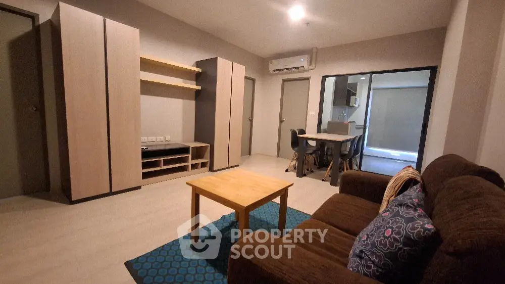 Modern living room with cozy brown sofa and stylish wooden furniture
