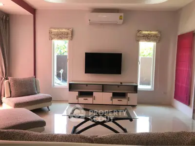 Modern living room with sleek furniture and wall-mounted TV