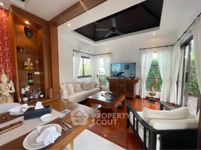 Luxurious living room with elegant decor and garden view, featuring wooden flooring and stylish furniture.