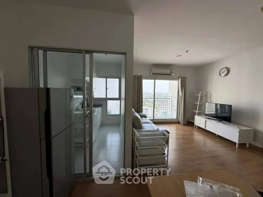 Modern living room with open kitchen and city view balcony