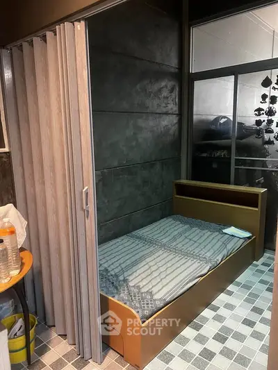 Compact bedroom with sliding partition and modern design elements.