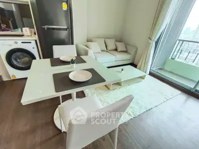 Modern living room with balcony view, featuring sleek furniture and in-unit washer for convenience.