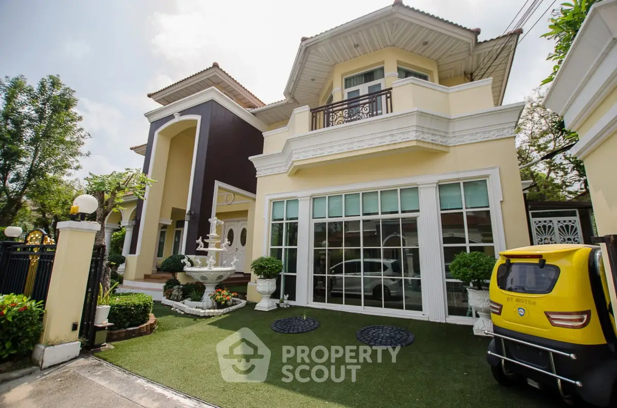 Elegant two-story house with manicured lawn and unique architectural design in a serene neighborhood.