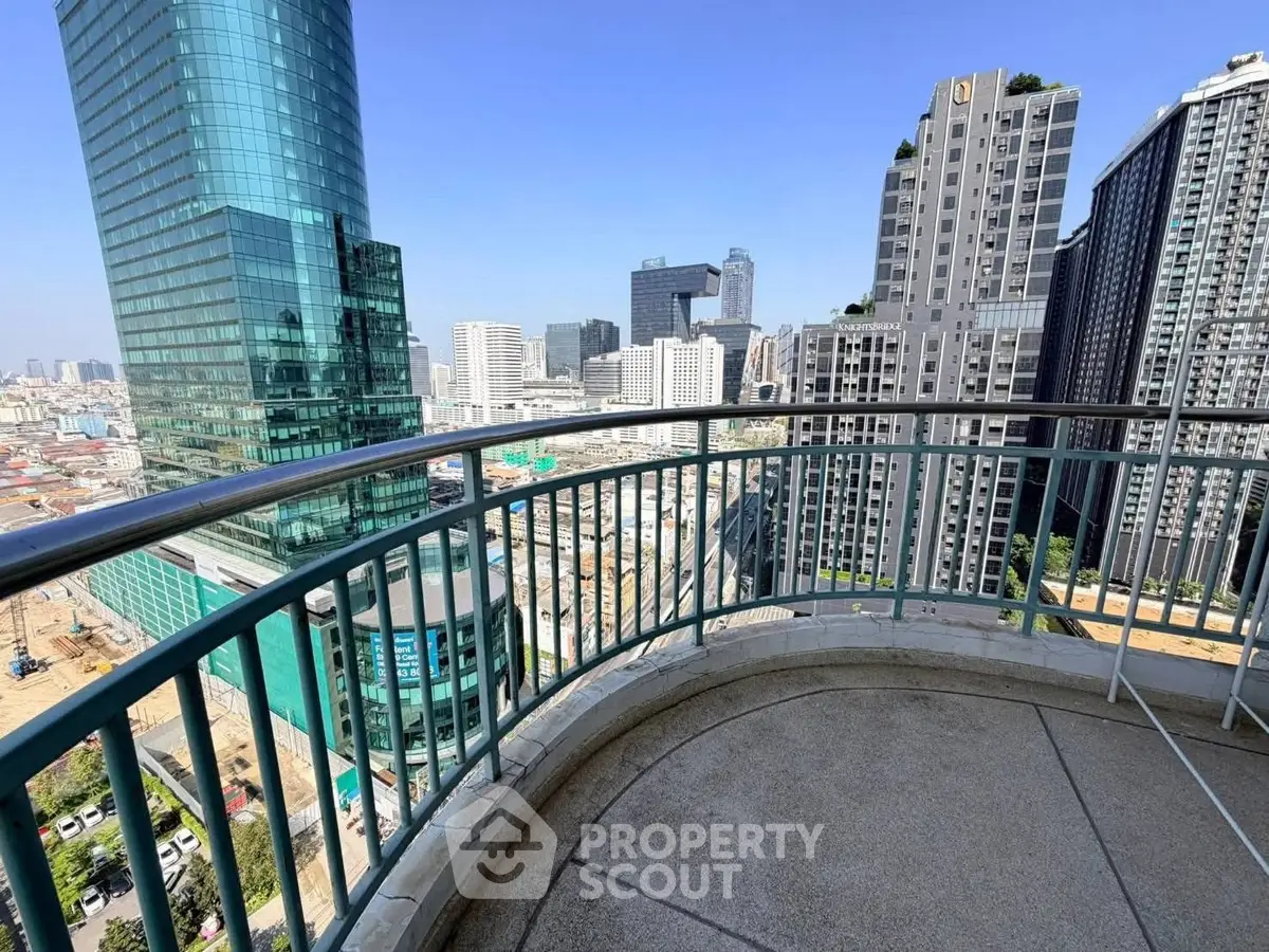 Stunning cityscape view from a high-rise balcony with modern skyscrapers in the background.