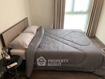 Cozy bedroom with modern decor and natural light, featuring a comfortable bed and stylish side table.