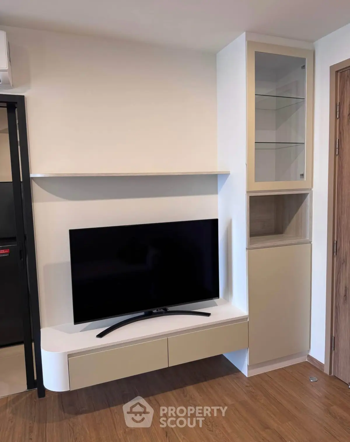Modern living room with sleek TV unit and wooden flooring