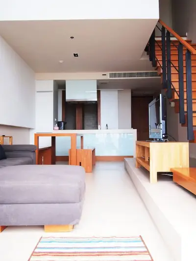 Modern living room with stylish staircase and open layout design