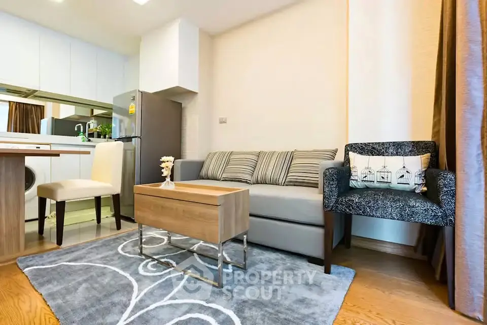 Modern living room with stylish furniture and open kitchen layout