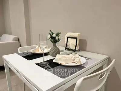 Chic dining area with elegant table setting in modern apartment interior.