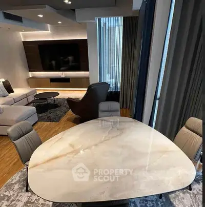 Luxurious modern living room with elegant marble dining table and cozy seating area.