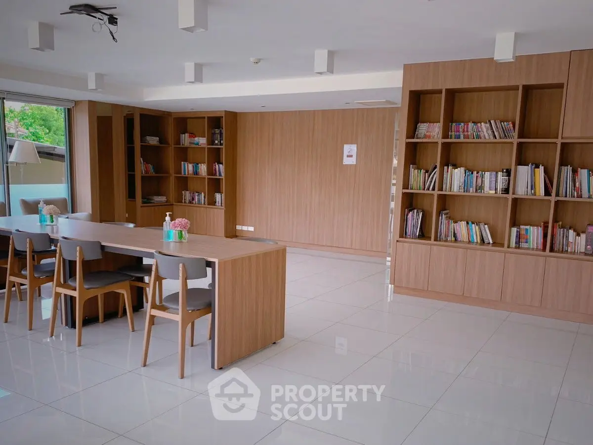 Spacious modern library with wooden bookshelves and sleek furniture