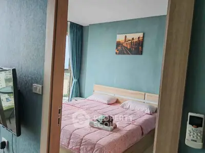 Cozy bedroom with modern decor and city view, featuring a comfortable bed and stylish wall art.