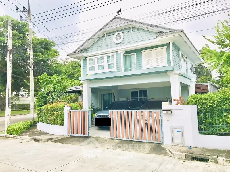 Charming two-story house with driveway and lush greenery in a serene neighborhood.