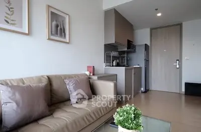 Modern living room with cozy sofa and compact kitchen in stylish apartment