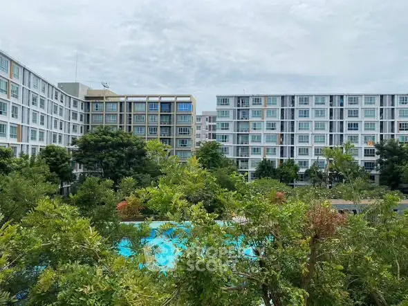 Modern apartment complex with lush greenery and pool view