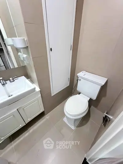Compact modern bathroom with sleek fixtures and neutral tiles
