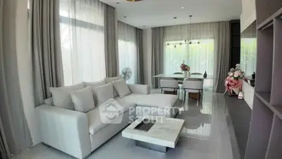 Elegant living room with modern decor and large windows offering natural light.