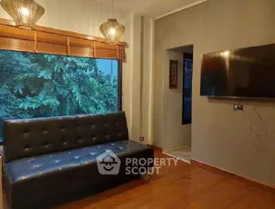 Cozy living room with large window and modern decor